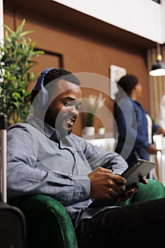 Black guy hotel guest browsing internet