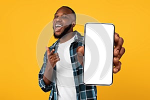 Black guy showing white empty smartphone screen, closeup