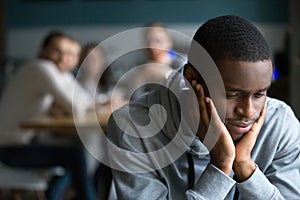 Black guy sit alone in cafe suffering from racial discrimination