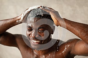 Black Guy Washing Head With Shampoo Taking Shower In Bathroom