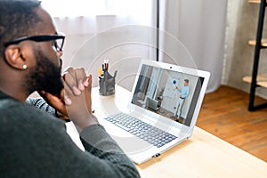 A black guy watching webinars online