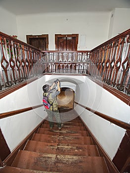 Black hair woman photographer study wooden staircase