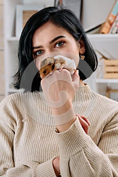 A Black-Haired Beauty Enjoys a Cozy Day at Home with Her Pet Mouse