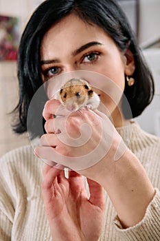 A Black-Haired Beauty Enjoys a Cozy Day at Home with Her Pet Mouse