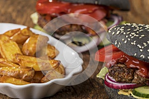 Black hamburgers on wood