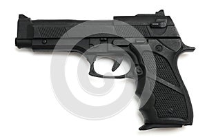 A black hammerless toy pistol against a white backdrop