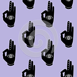 Black hand with eye mudra on a purple background buddhism hinduism symbol pattern seamless yoga India meditation zen hipster