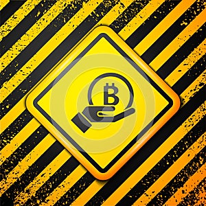 Black Hand holding Bitcoin icon isolated on yellow background. Blockchain technology, digital money market, cryptocoin