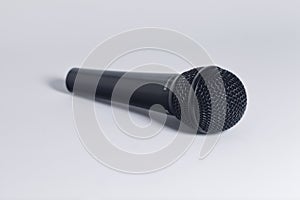 Black hand microphone on white background