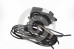 Black handcuff and flogging whip