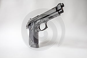 Black handgun on white background
