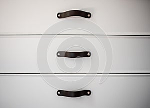 Black handles of the kitchen drawer or cabinet
