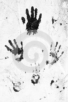 Black hands on grey concrete wall photo