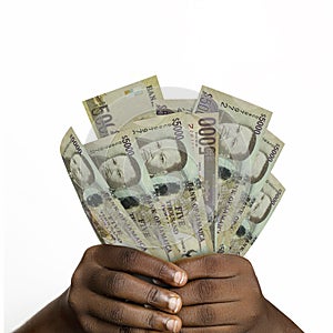 Black hands holding 5000 Jamaican notes. closeup of Hands holding Jamaican currency notes