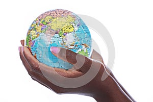 Black hands holding a world globe isolated