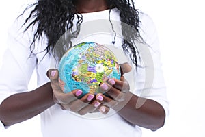 Black hands holding a world globe isolated