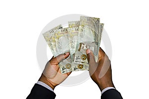 Black Hands in suit holding 20 Bahrain Dinar notes