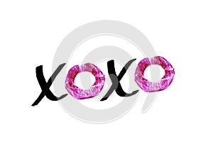 Black handwritten text XOXO with red lipstick imprints isolated on white background. Design element for posters, greeting cards wi