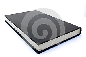 Black hard back book lying flat and closed with white background