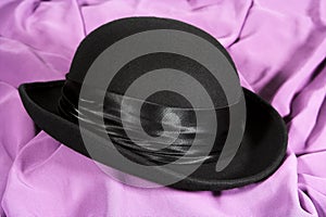 Black hat on a lilac backgroun