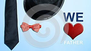 Black hat and red bow tie with a red heart and We Love Father\'s text