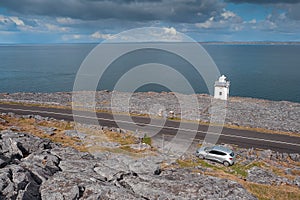 Black Head Lighthouse, county Clare, Ireland - 04.10.2021: Small car parked off the road. Wild Atlantic way, Beautiful nature