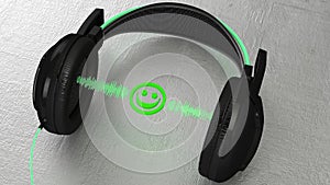 Black headphone with the green sound wave and a smiling face between the ear pieces