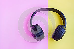 Black Headphone on pink and yellow background