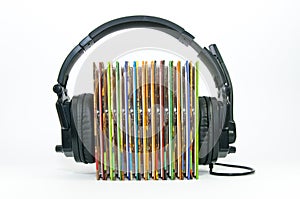 Black headphone , stack of colorful music cd.