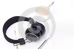 black headphones with a cup of coffee on a white background.