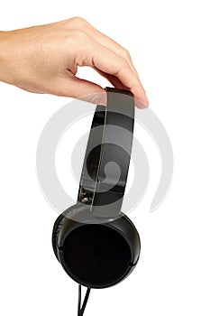 Black headphones in hand isolated on white background