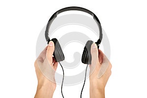 Black headphones in hand isolated on white background