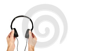 Black headphones in hand isolated on white background. copy space, template