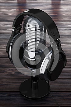 Black Headphones over Retro Microphone on a Wooden Table. 3d Rendering