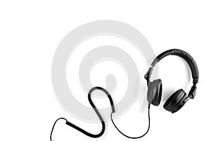 Black headphones with a wire on a white background