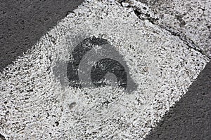 A black heart on a pedestrian crossing in a city