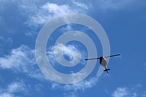 Black helicopter aircraft during the flight with blue sky