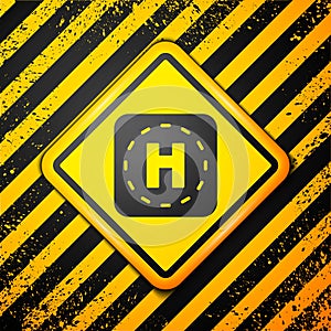 Black Helicopter landing pad icon isolated on yellow background. Helipad, area, platform, H letter. Warning sign. Vector