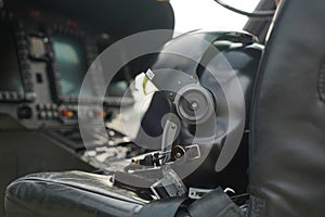 black helicopter pilot helmet, in the command chair with the control panel blurred, great detail