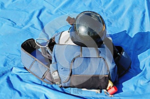 The black helmet and parachute bag