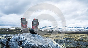 Black hiking boots and footwear outdoors in mountain scenery during trek