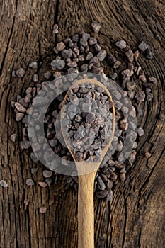 Black Himalayan salt (Namak shell salt) on a wooden background