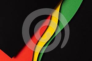 Black History Month color background. Abstract black, red, yellow, green color background with geometrical wavy lines