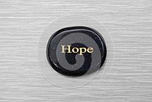Black Hope mood stone on gray background