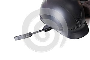 Black horse back riding gear: helmet and whip isolated on the white background