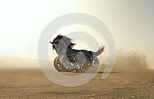 Black horse with car wheels instead of legs at high speed in the desert .