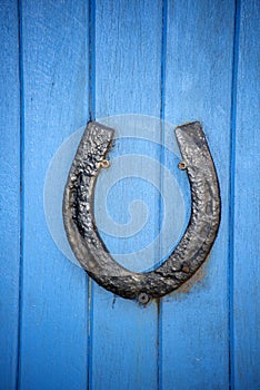 Black horseshoe on a blue door