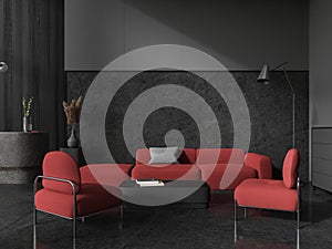 Black hotel interior lobby with armchairs and coffee table, reception desk