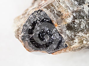 black Ilmenite close up in raw Nepheline close up photo