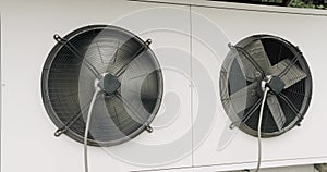 Black industrial fan rotates on a white background.